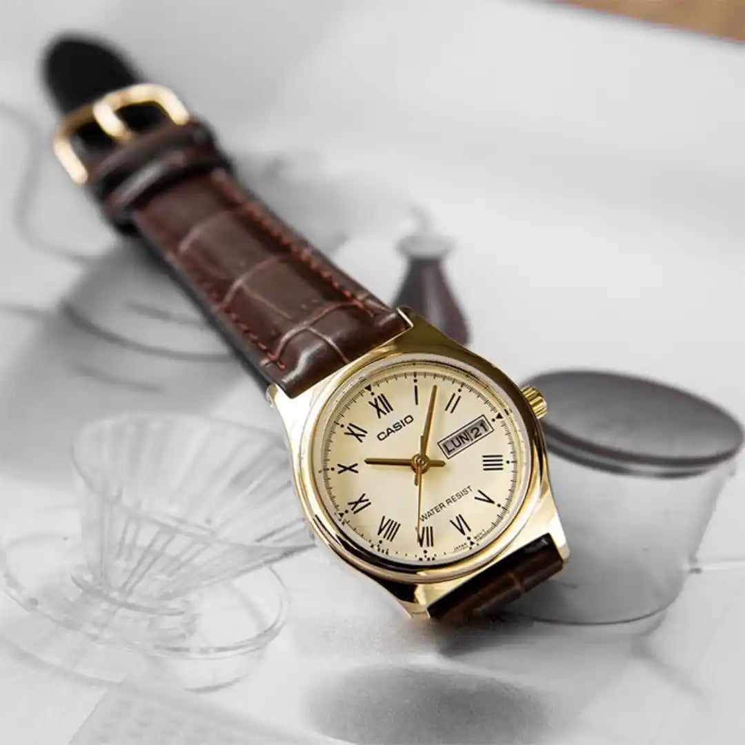 Casio LTP-V006GL-9B — watch arranged beside light-coloured accessories.