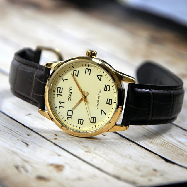 Casio MTP-V001GL-9B — angled view on a pale wooden surface.