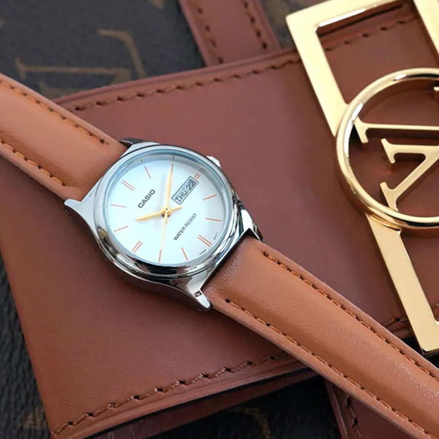 Casio LTP-V006L-7B2 — watch arranged beside brown accessories.