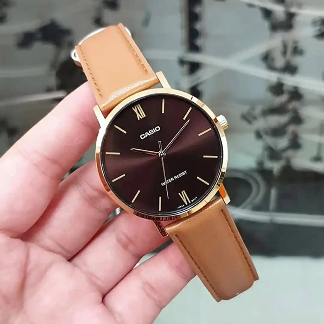 Casio MTP-VT01GL-5B — watch held in a hand.