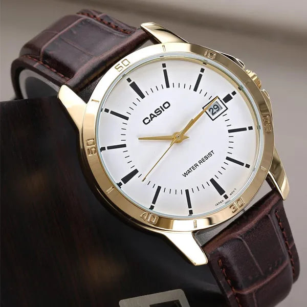 Casio MTP-V004GL-7A — angled close-up of white dial and brown strap.